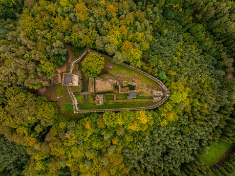 Aerial view of abandoned medieval Burg Helfenburk castle surrounded by autumn forest and trees, Ustek, Czech Republic.