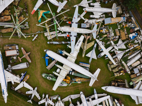 Aerial view of an abandoned airplane and helicopter graveyard with rusty metal aircraft collection, Zruc Senec, Czech Republic.