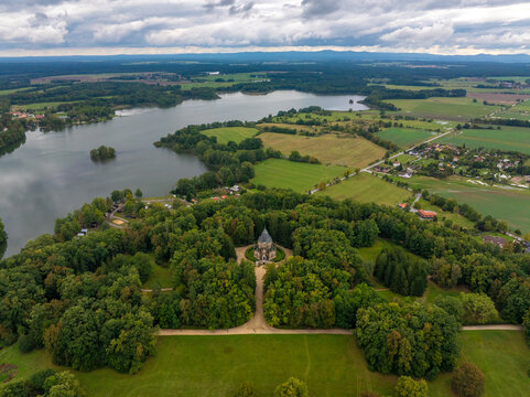 Aerial view of the serene schwarzenberg tomb surrounded by lush forest and tranquil lake, Trebon, Czech Republic.
