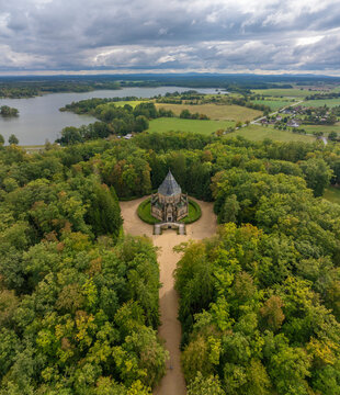 Aerial view of the serene schwarzenberg tomb surrounded by lush forest and tranquil lake, Trebon, Czech Republic.