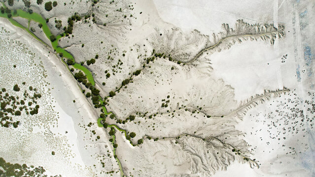 Aerial view of Willies Creek with abstract patterns of sand and vegetation, Kimberley Region, Australia.