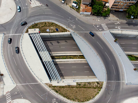 Aerial view of dynamic urban intersection with modern buildings and vehicles, Varna, Bulgaria.