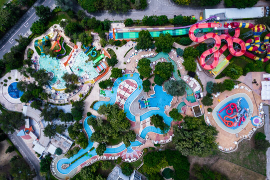 Aerial view of colorful water slides and pools surrounded by greenery, Albena resort, Bulgaria.