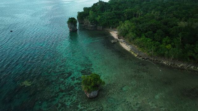 Aerial view of a beautiful tropical island at sunset with clear turquoise waters and lush forests, Port Vila, Vanuatu.
