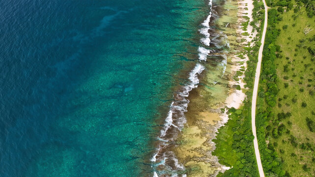Aerial view of a beautiful tropical island with pristine reef, turquoise waves, and lush greenery, Shefa, Vanuatu.