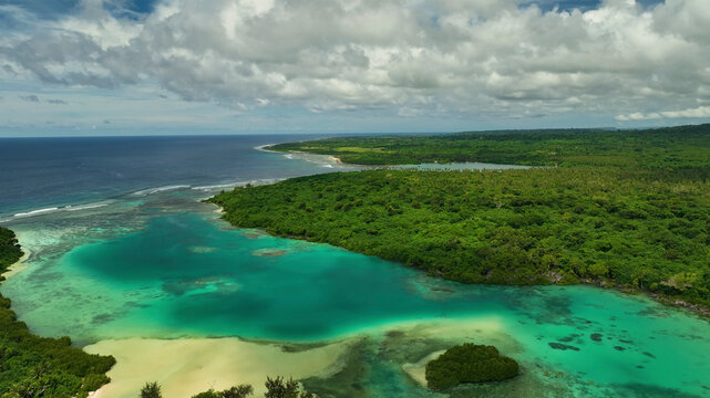 Aerial view of tropical island with lush palms and serene waves, Eton, Vanuatu.