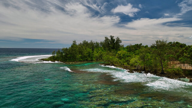 Aerial view of a tropical paradise island with lush palms, clear water, and coral reef, Shefa, Vanuatu.