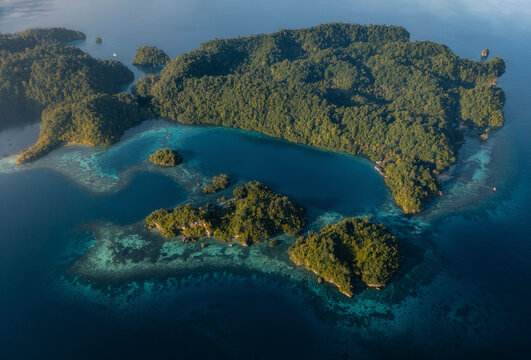 Aerial view of kididiri Resort and green islands in a tranquil lagoon, Tojo Una Una Regency, Indonesia.