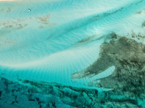 Aerial view of pristine turquoise waters and serene sandy beaches along the coastline, North Eleuthera, The Bahamas.