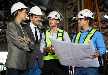 engineers and businesspeople talking about work or project on a construction site