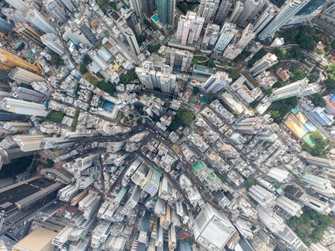 Aerial view of a bustling cityscape with modern skyscrapers and crowded streets, Central and Western, Hong Kong.
