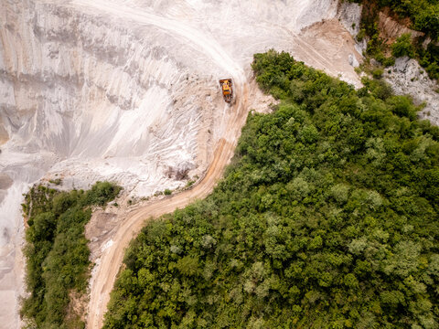 Aerial view of a beautiful quarry with heavy machinery and vegetation, Bila, Bosnia and Herzegovina.
