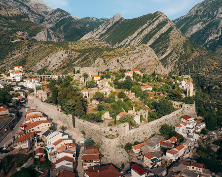 Aerial view of the picturesque old town of Stari Bar with historic stone walls and houses surrounded by mountains, Bar, Montenegro.