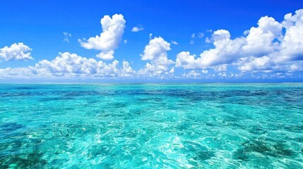 Fototapeta premium A stunning seascape featuring clear blue waters and fluffy clouds under a vibrant sky, evoking tranquility and natural beauty.