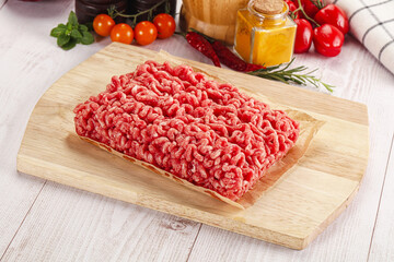 Raw minced beef meat over board