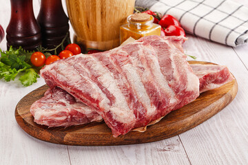 Raw pork ribs over board