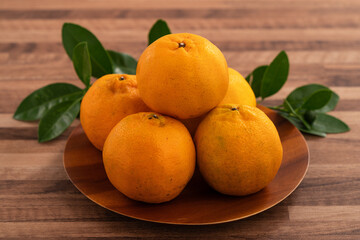 Fresh juicy tangerine mandarin orange on wooden table background.