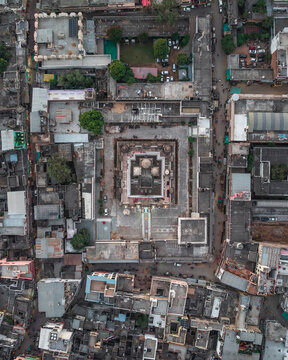 Aerial view of historic Rangji Temple surrounded by dense urban landscape and traditional buildings, Pushkar, Rajasthan, India.