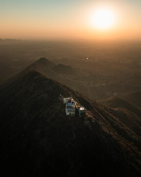 Aerial view of Shree Savitri Mata Temple on a mountain during sunset, Pushkar, Rajasthan, India.