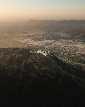 Aerial view of Shree Savitri Mata Temple on a serene mountain during sunset, Pushkar, Rajasthan, India.