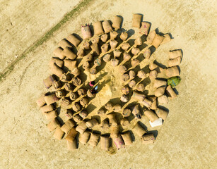 Aerial view of colorful sacks arranged in a circular pattern on the ground, Kastail, Bangladesh.