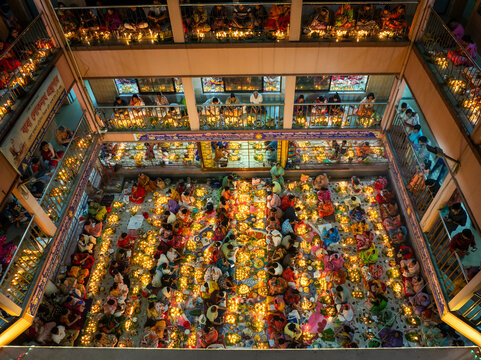 Aerial view of vibrant kartik vrata festival with illuminated candles and a gathering of people at the temple, Gendaria, Dhaka, Bangladesh.