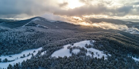 Aerial view of snowstorm clouds rolling over a mountain, dramatic contrast