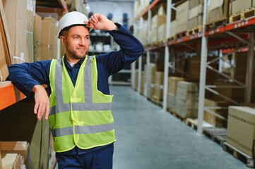 portrait of a smiling young warehouse worker working in a cash and carry wholesale store