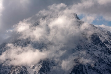 Aerial view of majestic snowy peaks of the Himalayan mountain range under dramatic clouds, Pakistan.