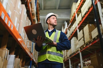 portrait of a smiling young warehouse worker working in a cash and carry wholesale store