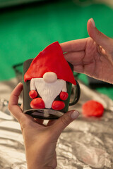 human hand decorating mug with ceramic clay for Christmas. High quality photo