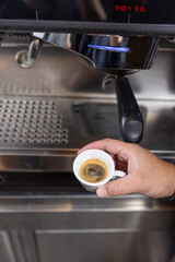 Professional barista preparing perfect cappuccino in the cafe bar