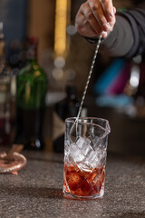 Bartender preparing alcohol cocktail in a glass