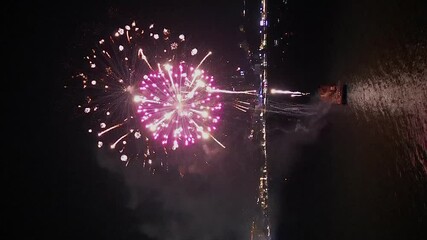 Vertical format aerial orbits fireworks show at Pattaya Beach, Thailand - Powered by Adobe