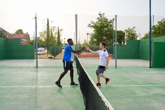 two paddle players greet each other at the end of the game