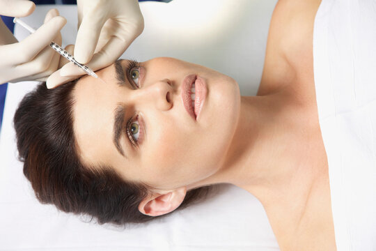 Woman Receiving Botox Injection on Forehead
