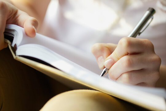Woman's Hands, Pen and Book
