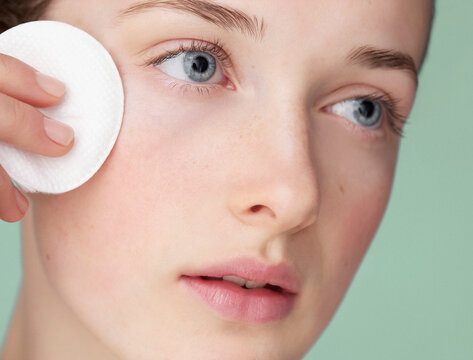 Young Woman Using Cleansing Cotton Pad
