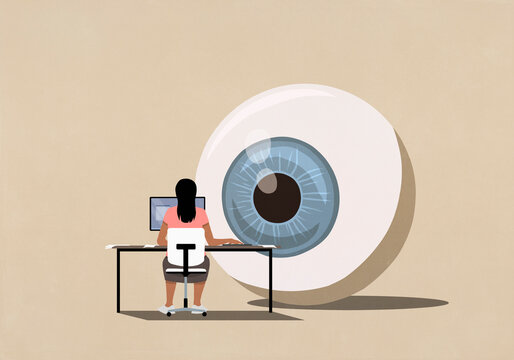 Large surveillance eyeball watching woman using computer at desk
