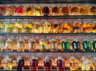 Canned vegetables and fruits in large glass jars on display. Homemade pickles and marinades.