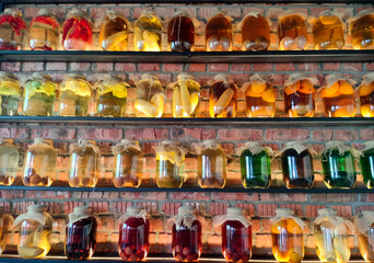 Canned vegetables and fruits in large glass jars on display. Homemade pickles and marinades.