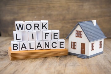 Fototapeta premium Work life balance concept with a house model