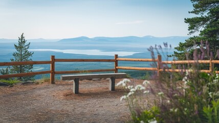 Fototapeta premium A wooden bench overlooking a scenic vista with mountains and a lake in the distance.