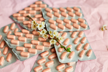 Overhead View of Multiple Blister Packs of Medication on a Crumpled Pink Surface