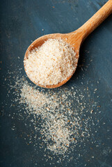 Dietary fiber-rich psyllium husks in charming wooden heart-shaped tableware.