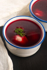 Traditional polish clear red borscht with dumplings with mushrooms