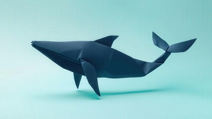 Fototapeta premium Origami whale on a soft blue background.