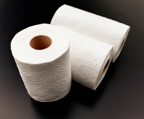 Toilet paper roll isolated on black background.