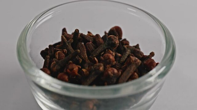 cloves in small glass bowl, closeup, 4k, parallax shot.