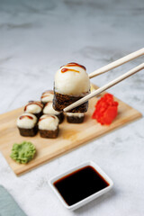 sushi rolls with baked cheese, unagi sauce close up, sesame, lemon, soy sauce, ginger, wasabi, sushi set on a light background, still life, food, Japanese cuisine